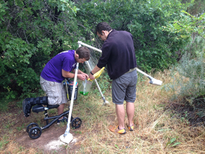 Toby and Kenyon Gentry collecting insects from one of their combi-traps for flying insects